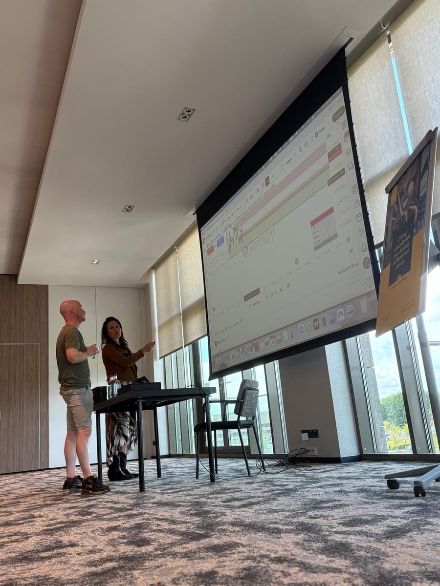 Two people at the front of the room during a session.